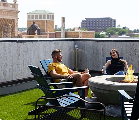 People relaxing by a fire pit.